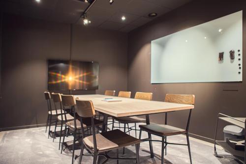 a conference room with a wooden table and chairs at Best Western Plus Hus 57 in Ängelholm