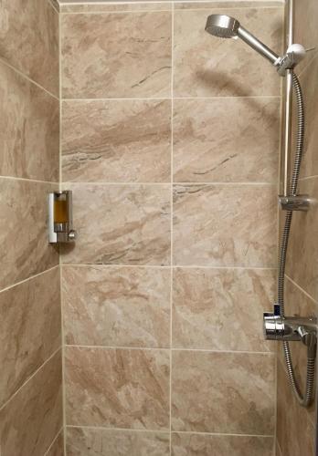 a shower stall with a shower head in a bathroom at Plumpton Court in Nawton