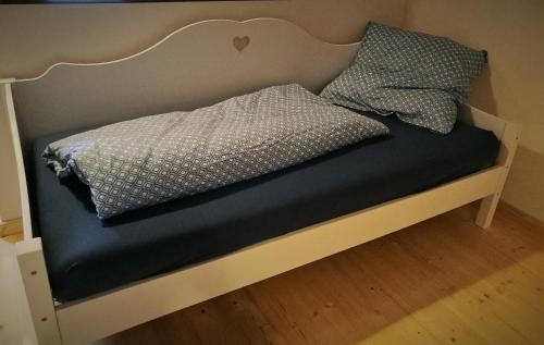a bed with two pillows on top of it at Beim Hooch "Josef" in Brücktal