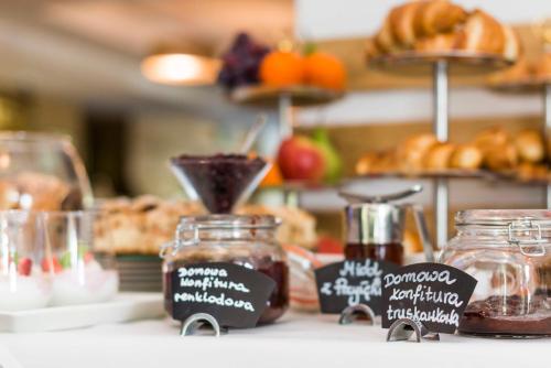 a table with jars of jam and other food items at Apartamenty przy Hotelu Żywieckim in Przyłęków