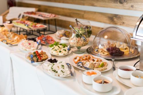 a buffet with many plates of food on a table at Apartamenty przy Hotelu Żywieckim in Przyłęków
