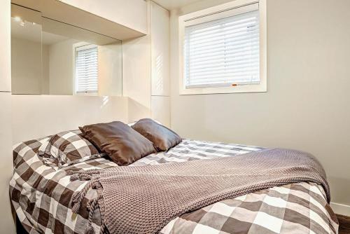 a bedroom with a bed with a blanket on it at Condo 09 Chemin des Abruzzes by Les Chalets Alpins in Stoneham