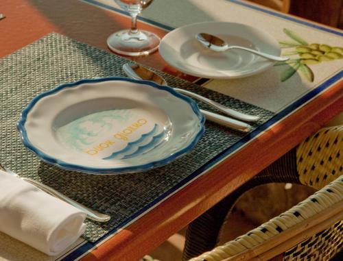 a table with a plate on a table at Monastero Santa Rosa Hotel & Spa in Conca dei Marini