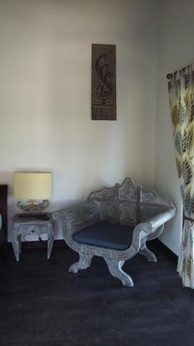 a room with a couch and a table and a lamp at Lovina Paradise in Lovina