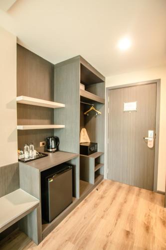 a kitchen with gray cabinets and a counter top at Hotel MAYU Chiang Mai in Chiang Mai