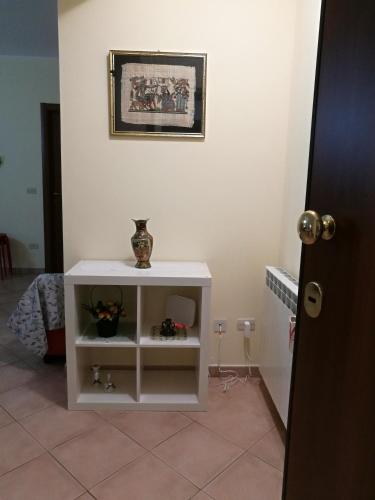 a white cabinet with a vase on it in a room at Relax House in Giardini Naxos