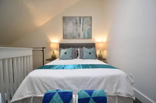 a bedroom with a large bed with blue and green pillows at BOUTIQUE LOFT unit 4 in Hollywood