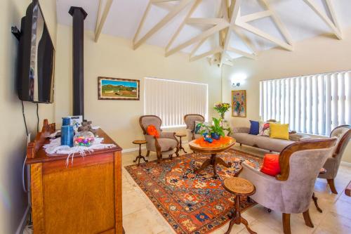 a living room with a couch and a tv at Bergsig B & B in Knysna