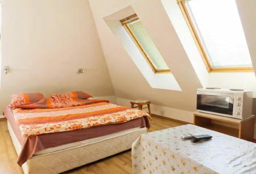 a bedroom with two beds and a tv and a table at Stay Nexus near Airport in Sofia