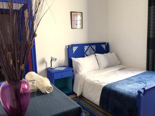 a bedroom with a bed and a vase next to a table at El Muniria in Tangier