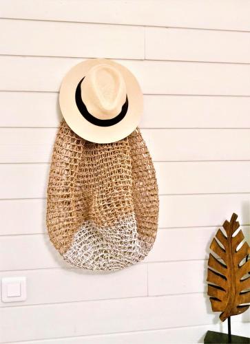 a hat and a bag hanging on a wall at Villa La Voile Blanche in Orient Bay