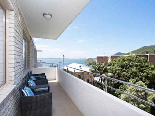 a balcony with chairs and a view of the ocean at Del Rae Unit 18 25 Shoal Bay Road in Shoal Bay