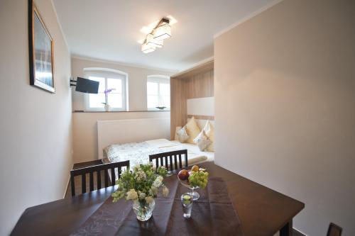 a room with a dining table and a bed at Guest house Villa Fritz in Potsdam