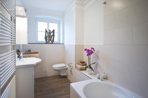 a white bathroom with a toilet and a sink at Guest house Villa Fritz in Potsdam