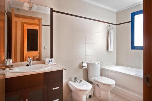 a bathroom with a toilet and a sink and a tub at Alicante Hills in Alicante