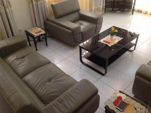 a living room with a couch and a coffee table at Bastos'Appart YAOUNDE in Yaoundé