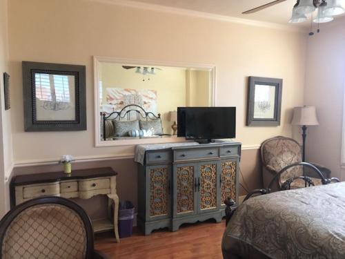 a bedroom with a bed and a television on a dresser at Mayflower Hotel in San Francisco