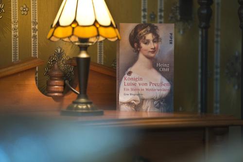 a lamp sitting on a table next to a book at Guest house Villa Fritz in Potsdam