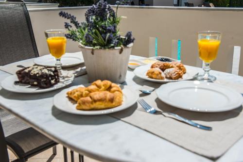 a table with plates of food and drinks on it at Lefkadio in Lefkada Town