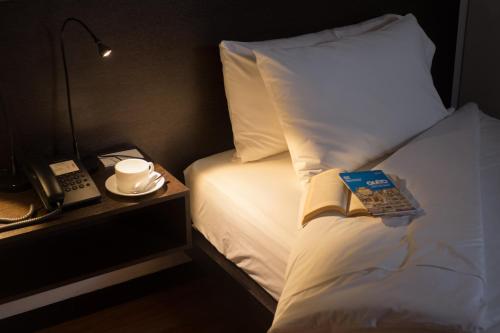 a hotel room with a bed with a book on it at Casa Q in Quito