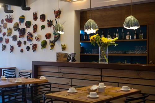 a restaurant with two tables and a bar with butterflies on the wall at Casa Q in Quito