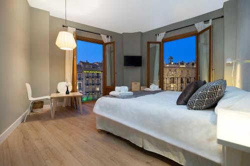 a bedroom with a large bed with a view of a city at Pension Boutique Gomerez Gallegos in Granada