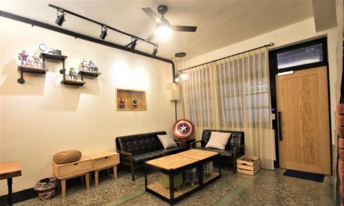 a living room with a couch and a table at 台東市區 童年時光六人包棟民宿 附廚房及電動麻將 in Taitung City