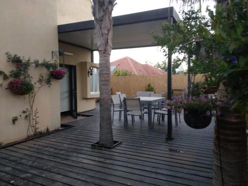 a wooden deck with a table and chairs on it at Sweet Home in Arad