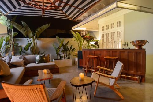 a living room with a couch and chairs and plants at Villa Barranco by Ananay Hotels in Lima