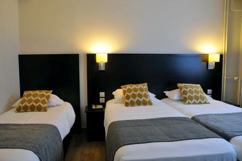 Katil atau katil-katil dalam bilik di Hôtel Des Quatrans