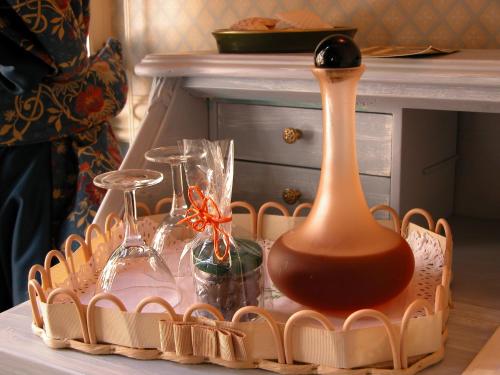 a tray with glasses and a bottle on a table at Il Sole Di Ranco in Ranco