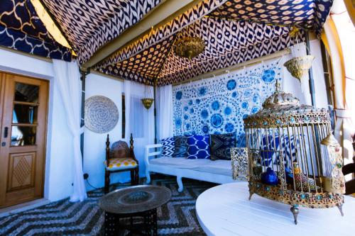 a living room with blue and white walls and a couch at Melenos Art Boutique Hotel in Líndos