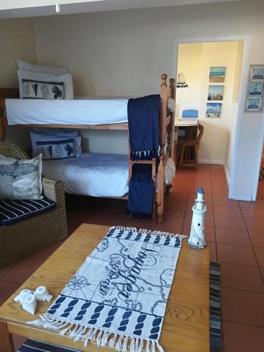 a living room with two bunk beds and a table at Lighthouse Accommodation in East London