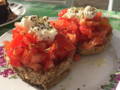 two pieces of bread with tomatoes on top on a plate at Thalassitra Private Pool Suites in Adamas