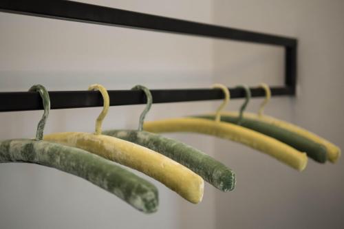 a bunch of cucumbers hanging on a rack at Family Affair Luxury Rooms&Suites in Palermo