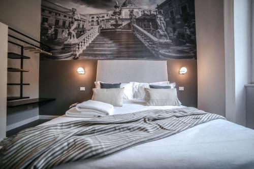 a bedroom with a large bed with a painting on the wall at Family Affair Luxury Rooms&Suites in Palermo