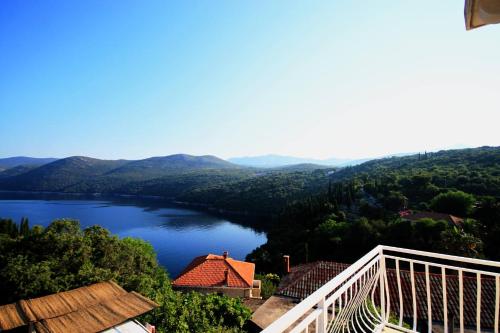 a view of a lake from a balcony at Diving Apartments in Molunat