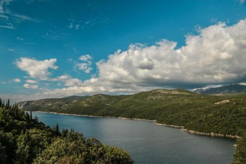 a view of a lake in the mountains at Diving Apartments in Molunat