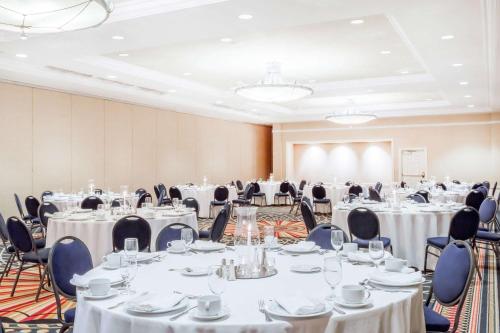a conference room with tables and chairs with white tablecloths at Wyndham Gettysburg Hotel & Conference Center in Gettysburg