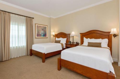 a hotel room with two beds and a window at The George Washington - A Wyndham Grand Hotel in Winchester