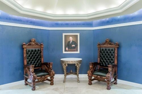 a blue room with two chairs and a table at Wyndham Gettysburg Hotel & Conference Center in Gettysburg