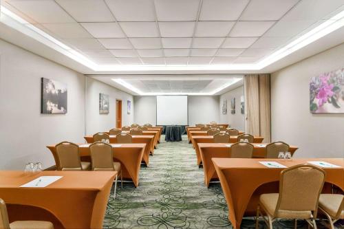a room with rows of tables and chairs at Wyndham Garden Hotel Austin in Austin