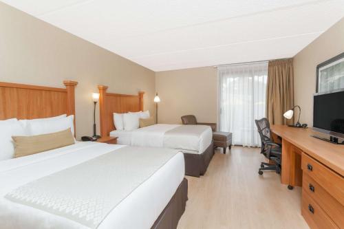 Ένα ή περισσότερα κρεβάτια σε δωμάτιο στο Wyndham Garden Hotel Austin