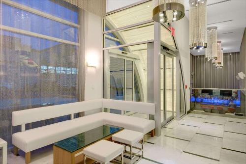 a lobby with a table and chairs and a window at Wyndham Garden Brooklyn Sunset Park in Brooklyn