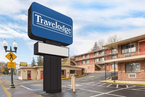 a sign in a parking lot in front of a building at Travelodge by Wyndham Klamath Falls in Klamath Falls