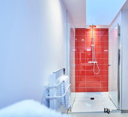 a bathroom with a shower with red tile at Le Manoir de Kerbot in Sarzeau