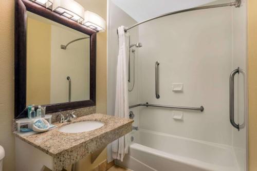 a bathroom with a sink and a shower and a tub at Wyndham Garden Summerville in Summerville