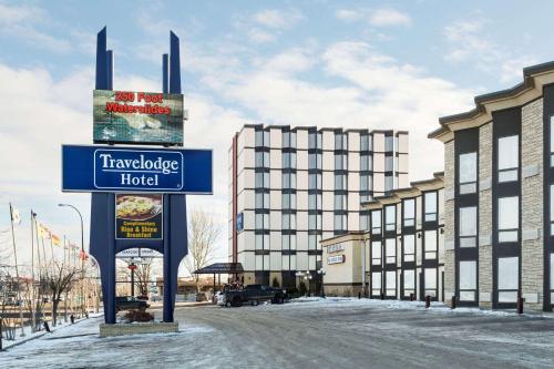 a sign for a hotel in front of a building at Travelodge by Wyndham Lloydminster in Lloydminster