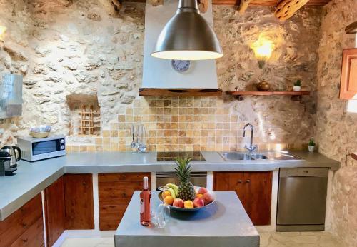 a kitchen with a bowl of fruit on a counter at Villa Sa Paissa in Cala Vadella