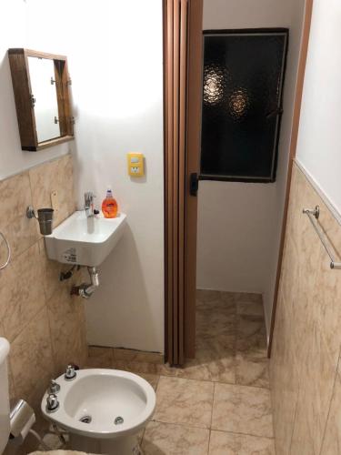 a bathroom with a toilet and a sink at Departamento Reconquista in Villa María